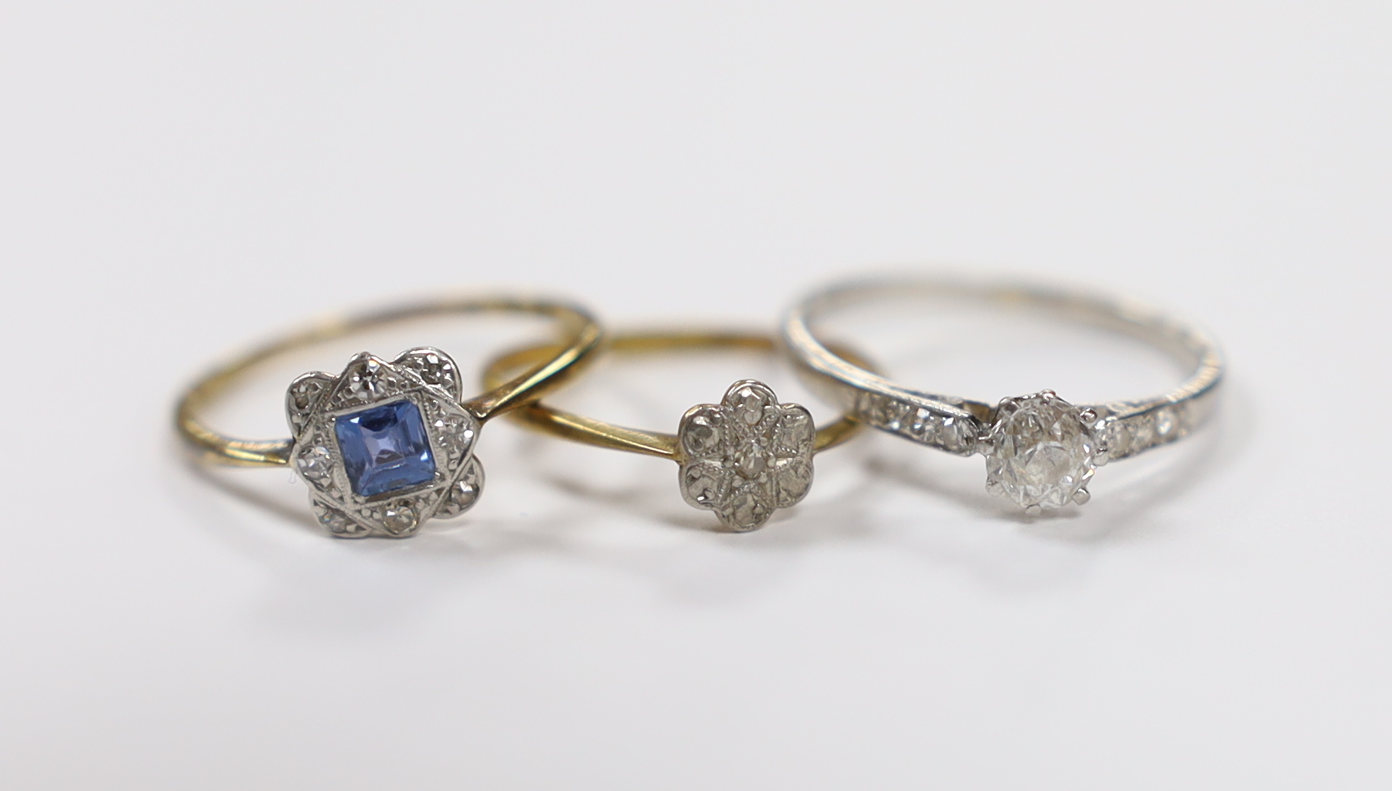 A white metal and single stone diamond ring, with diamond chip set shoulders, size N and two 1920's 18ct rings, sapphire and diamond cluster and single stone diamond, gross weight 4.9 grams.